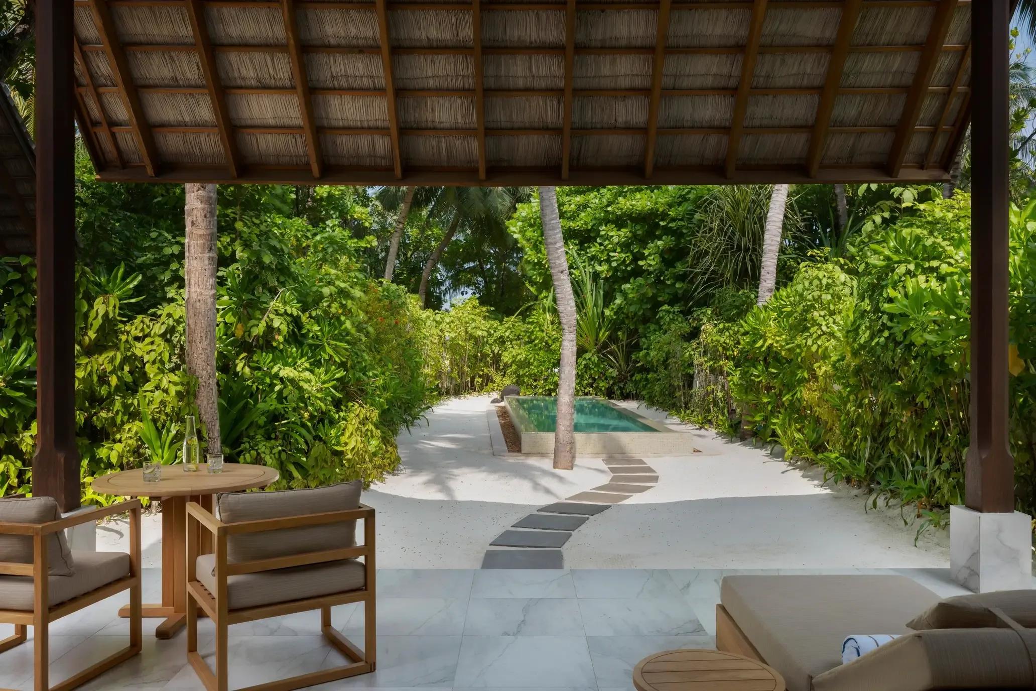 A Two-Bedroom Deluxe Beach Villa's private pool and garden path at Conrad Maldives Rangali