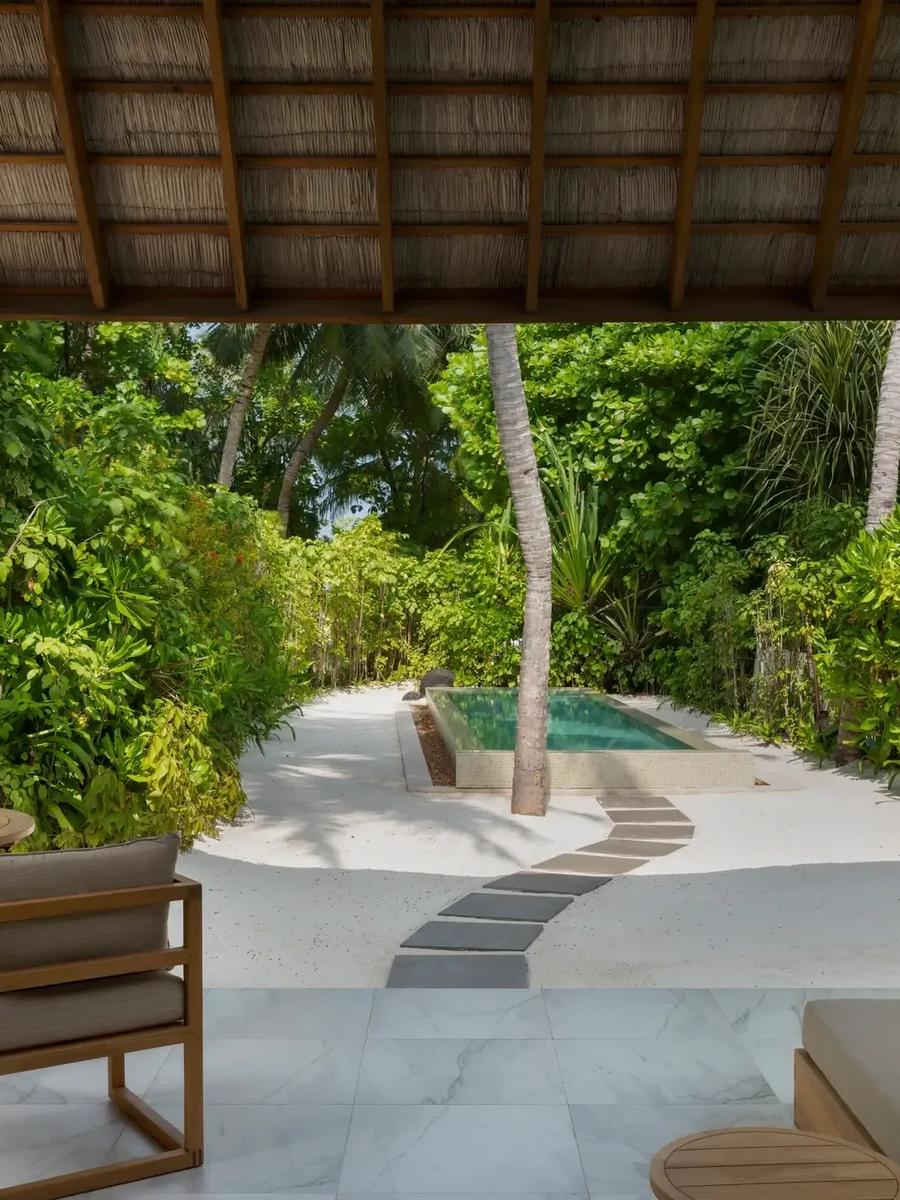 A Two-Bedroom Deluxe Beach Villa's private pool and garden path at Conrad Maldives Rangali