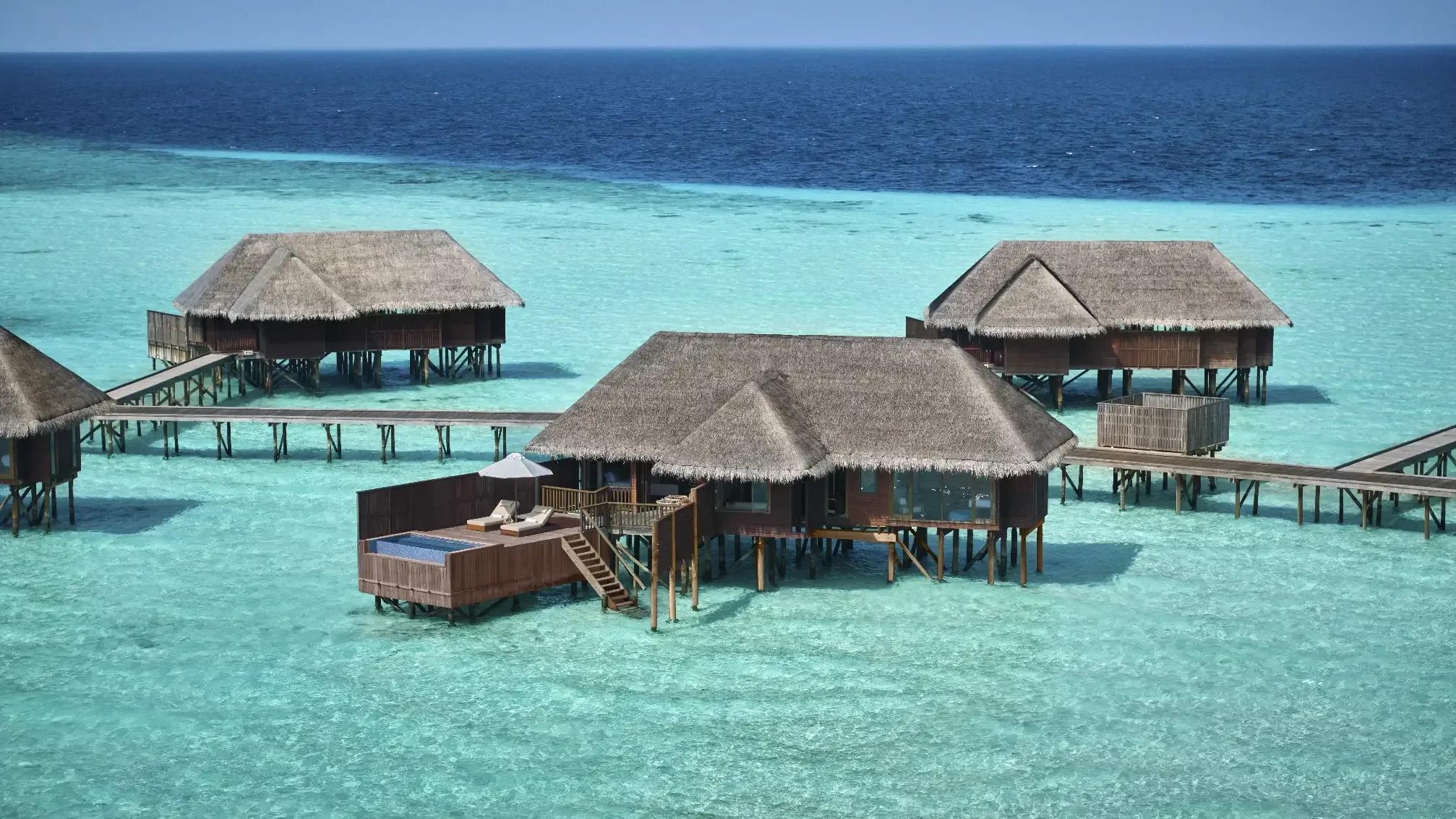 An aerial view of Two-Bedroom Grand Water Villas with private pools over the lagoon at Conrad Maldives Rangali