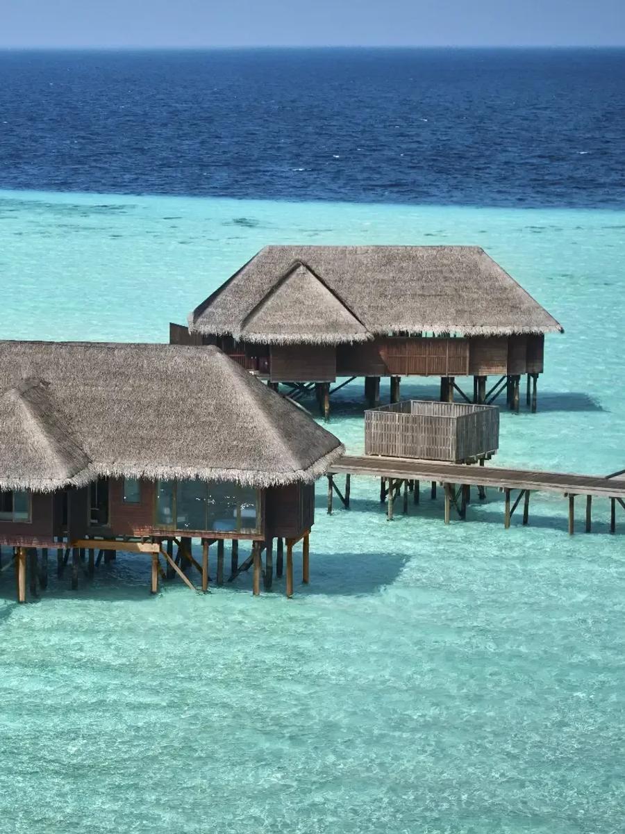 An aerial view of Two-Bedroom Grand Water Villas with private pools over the lagoon at Conrad Maldives Rangali