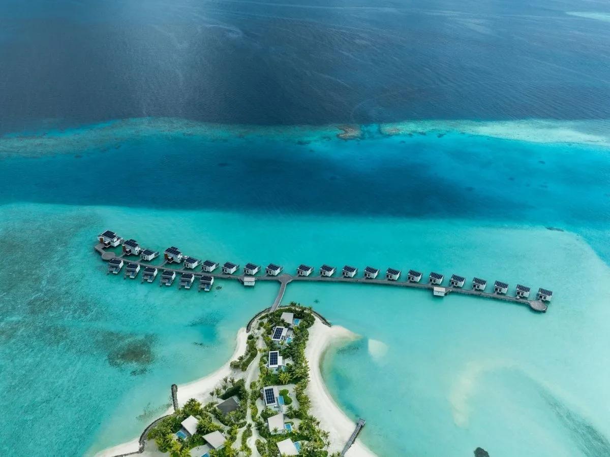 Aerial view of the overwater villa jetty reaching from SO/ Maldives' island out into Emboodhoo Lagoon