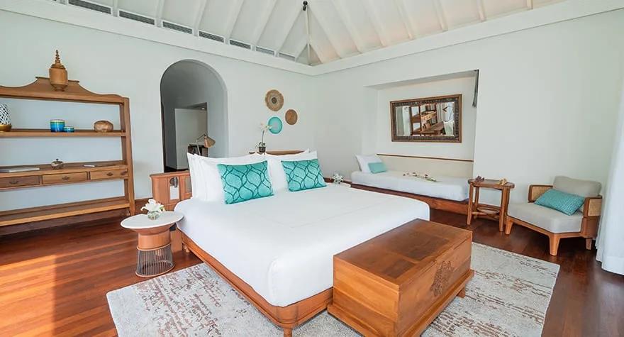 Bedroom of a One Bedroom Family Over Water Pool Villa at Anantara Kihavah, with the kids' twin beds visible