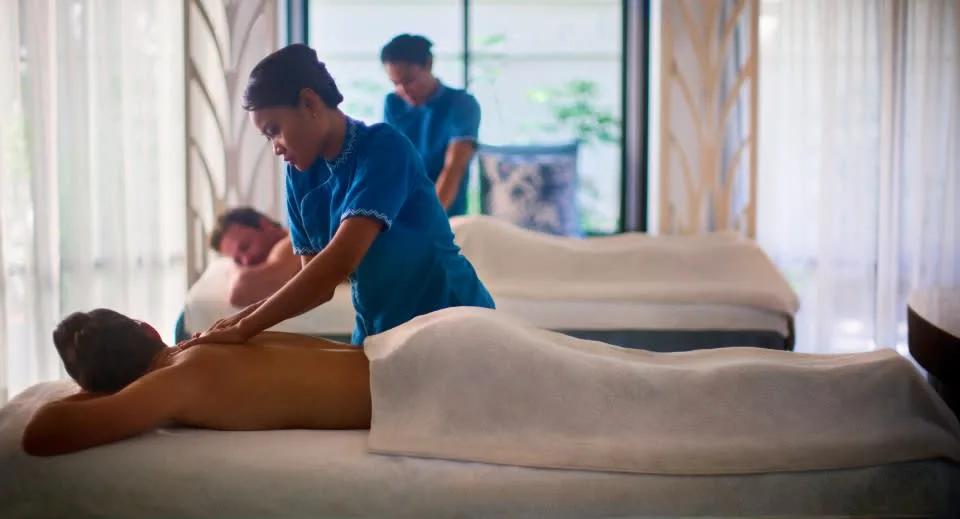A couple receiving an Ayurvedic massage side by side at Balance Wellness by Anantara