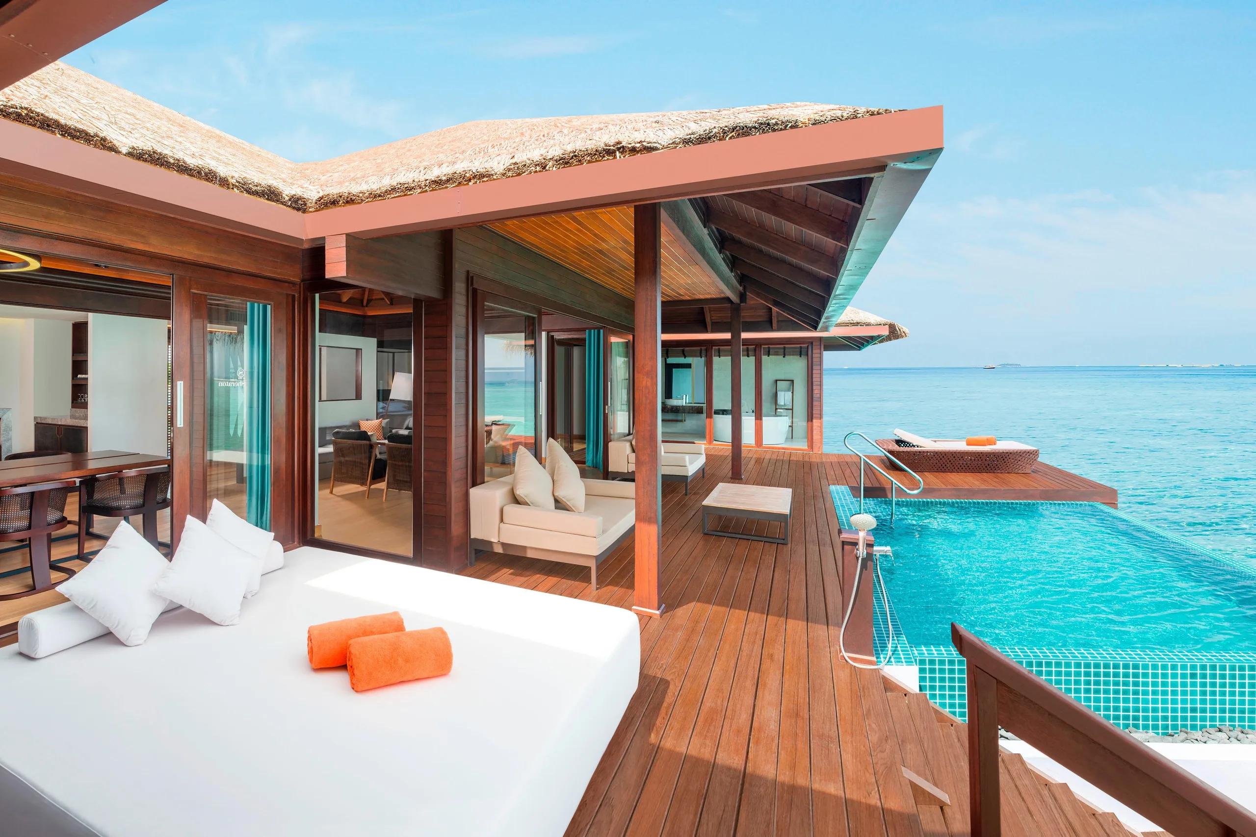 Private overwater pool deck of the Premium Overwater Villa With Pool, with a shaded lounger and open ocean beyond the pool edge