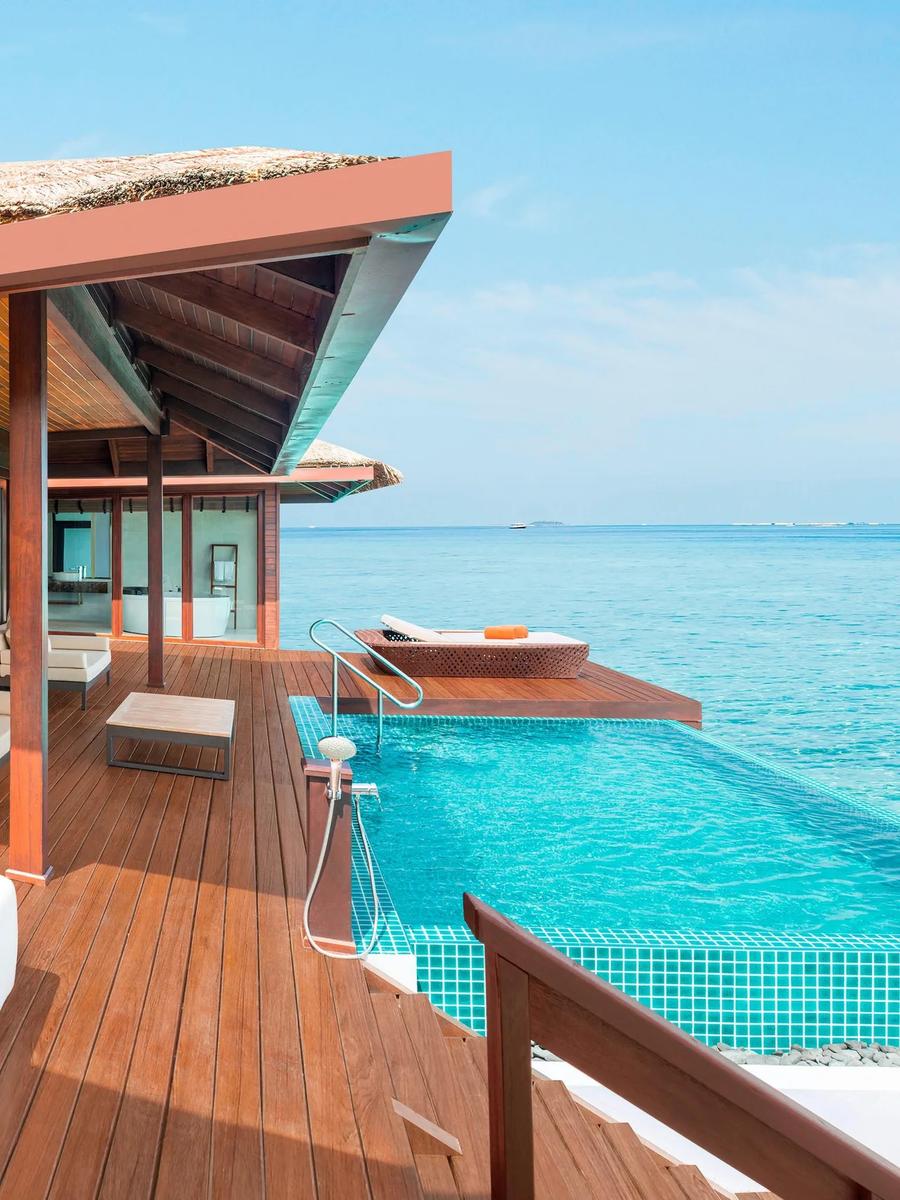 Private overwater pool deck of the Premium Overwater Villa With Pool, with a shaded lounger and open ocean beyond the pool edge