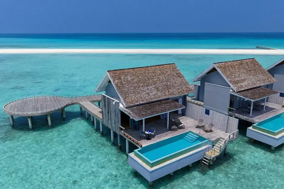 Aerial view of a Thundi Water Villa with Pool, its private pool over the lagoon and the island's sandbank visible in the background
