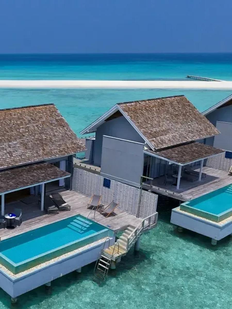 Aerial view of a Thundi Water Villa with Pool, its private pool over the lagoon and the island's sandbank visible in the background