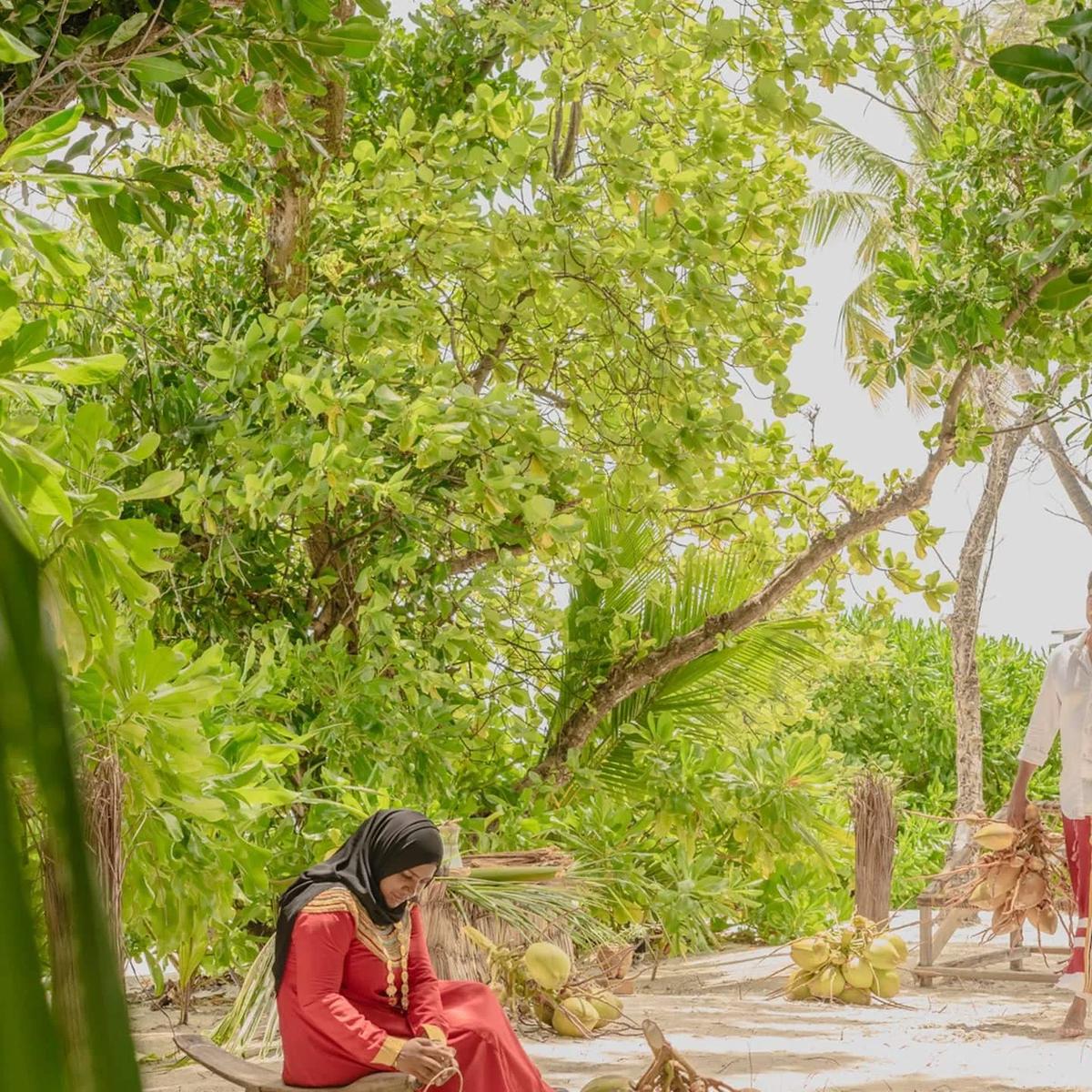 A guest taking part in Coconut Reverence, a guided craft session exploring the island's coconut-palm traditions