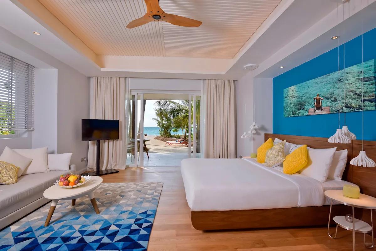 A Beach Villa's bedroom opening onto its terrace and private swirl pool