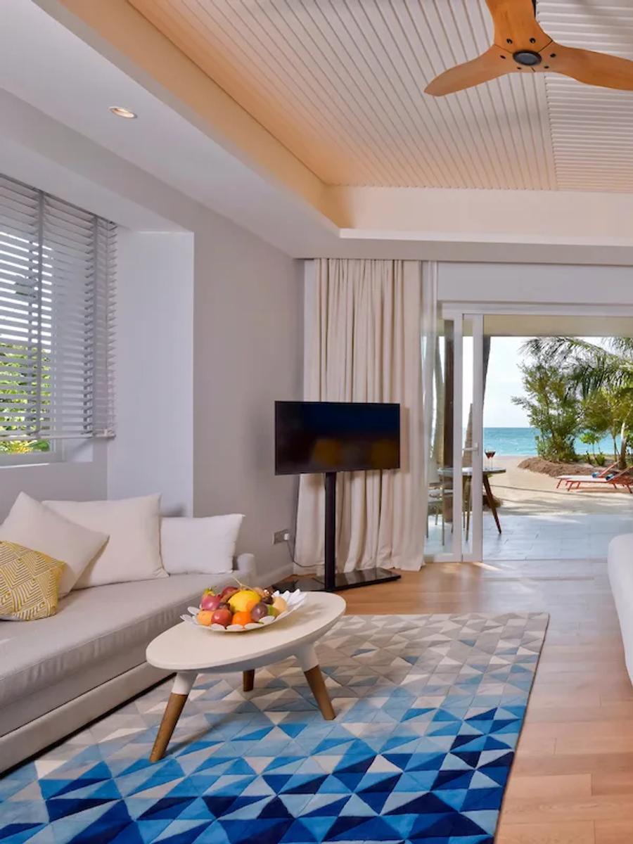 A Beach Villa's bedroom opening onto its terrace and private swirl pool
