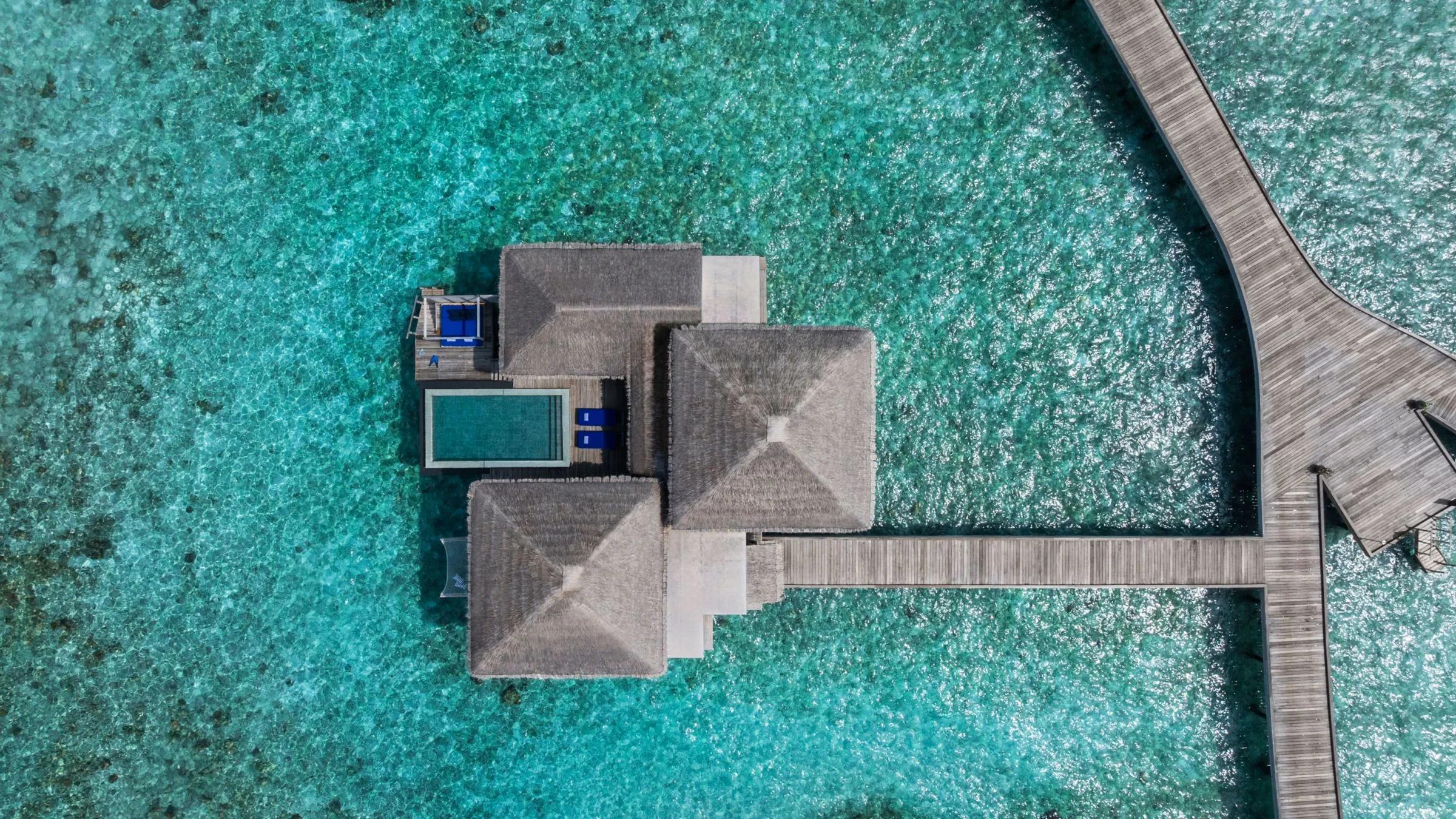 Overwater Villas seen from above, private pools stepping out across the lagoon