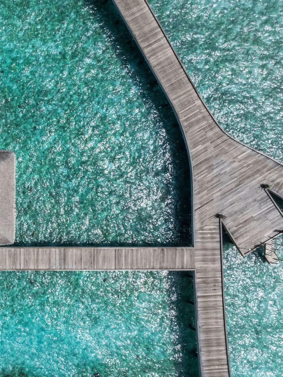 Overwater Villas seen from above, private pools stepping out across the lagoon
