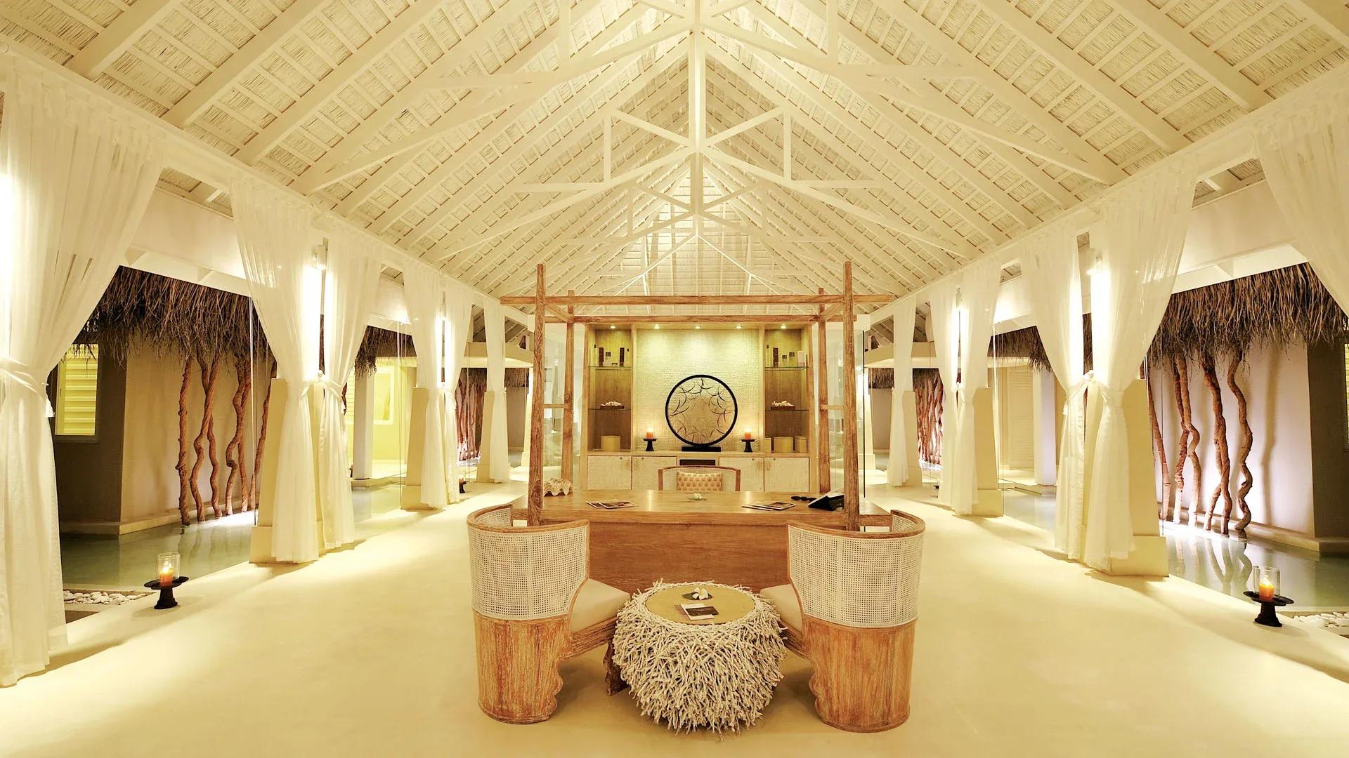 AySpa's reception hall, a vaulted thatch ceiling and driftwood decor lining the corridor to the treatment villas