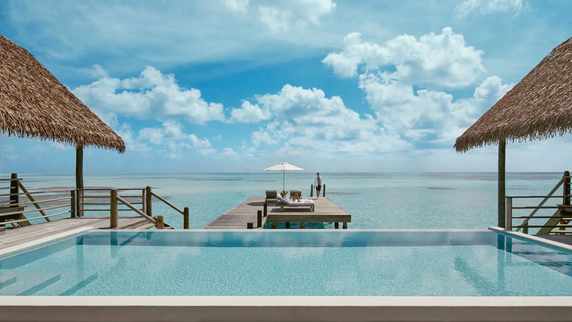 The Two-Bedroom COMO Sunrise Villa's private pool and jetty, extending out over open water