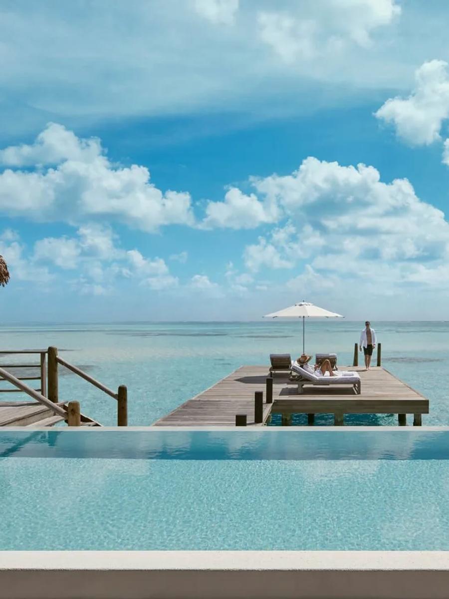 The Two-Bedroom COMO Sunrise Villa's private pool and jetty, extending out over open water