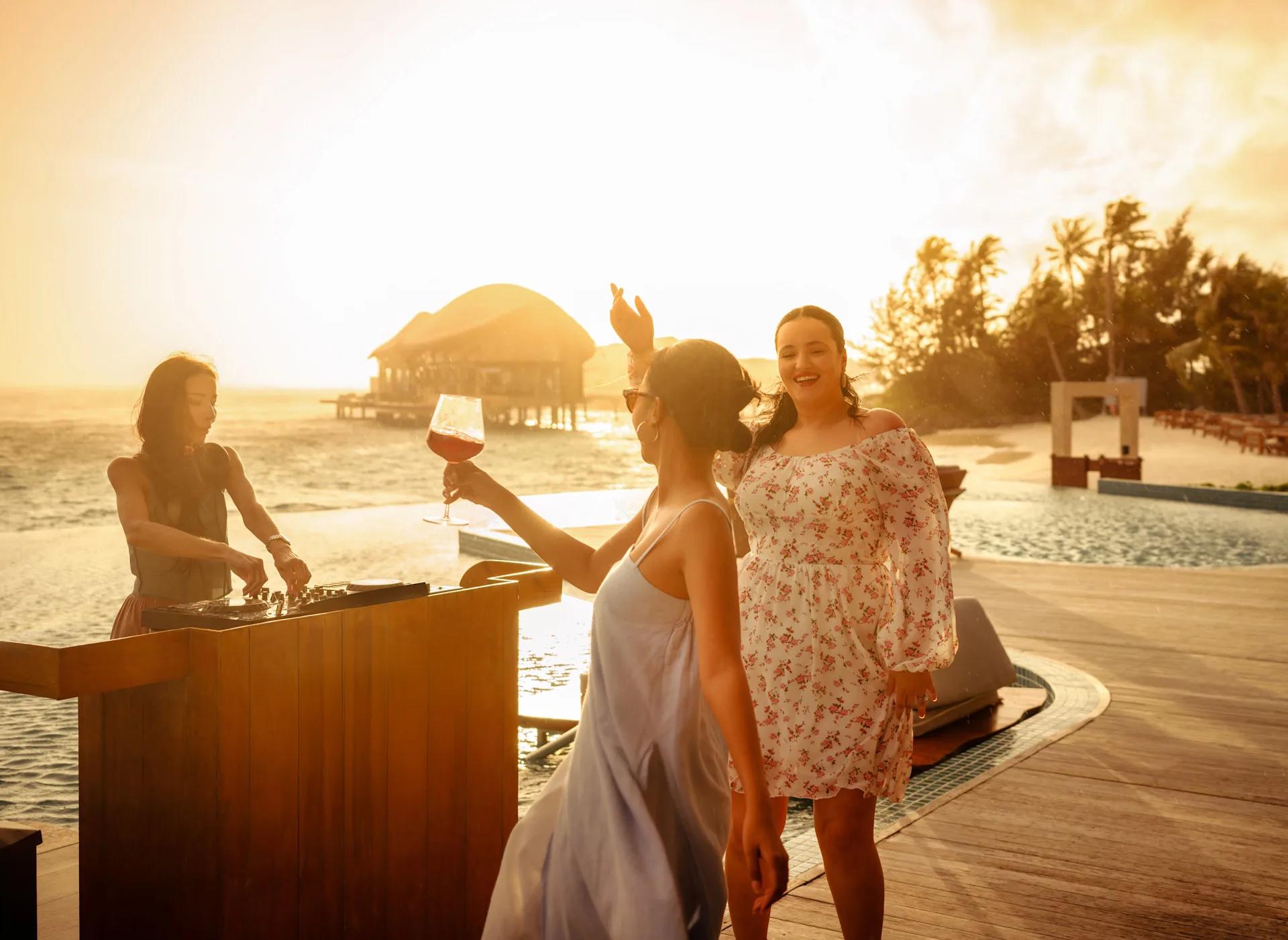 Sundowners at Aura Pool Bar — Re:Fuel has no dedicated photography on the official site, so this stands in as the closest available evening-lounge scene from the resort's own image set