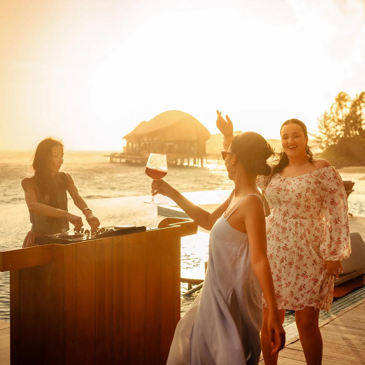 Sundowners at Aura Pool Bar — Re:Fuel has no dedicated photography on the official site, so this stands in as the closest available evening-lounge scene from the resort's own image set