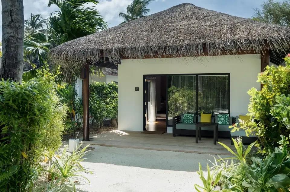 Deluxe Villa with Pool's garden entrance, thatched roof over a shaded outdoor lounge