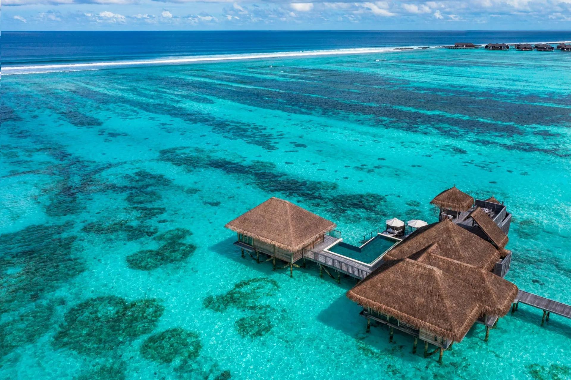 Aerial view of a Family Villa with Pool at Gili Lankanfushi, showing its L-shaped infinity pool