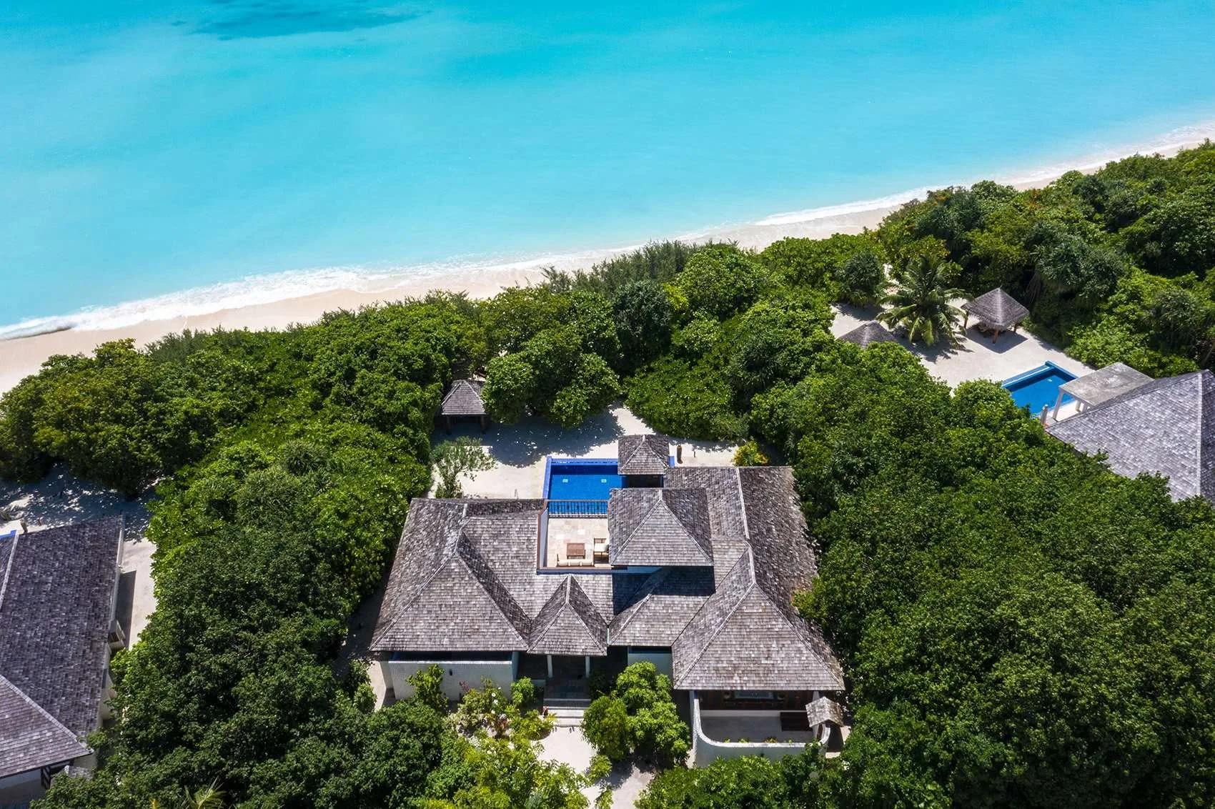Aerial view of a Two-Bedroom Beach Residence with Pool, its pool and two poolside gazebos steps from the beach