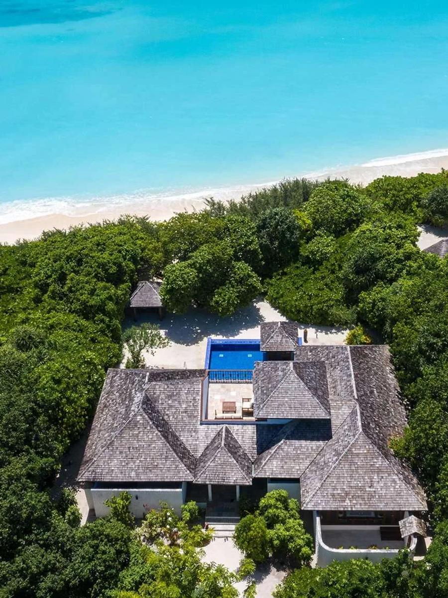 Aerial view of a Two-Bedroom Beach Residence with Pool, its pool and two poolside gazebos steps from the beach