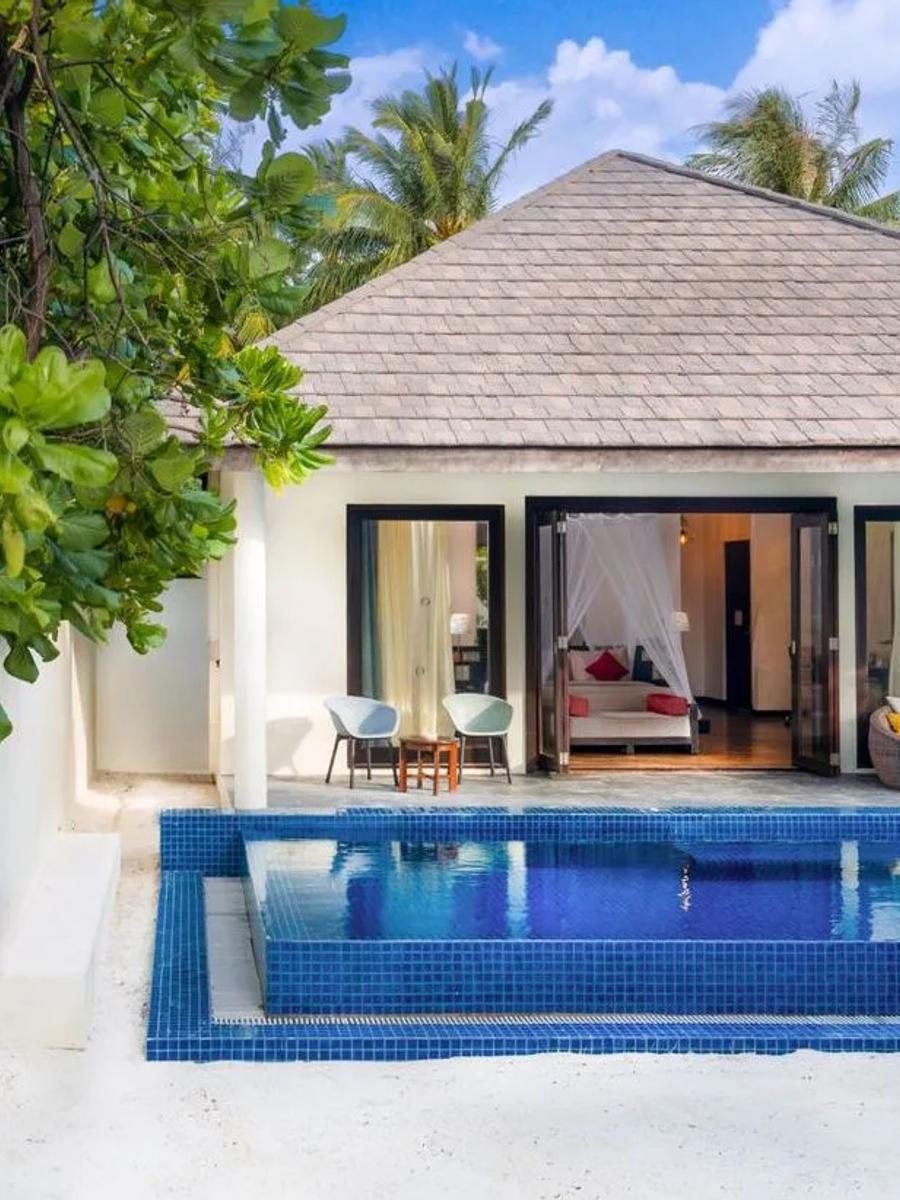 A Sunset Beach Villa with Pool's exterior deck, its private pool and colourful daybed seating just off the bedroom