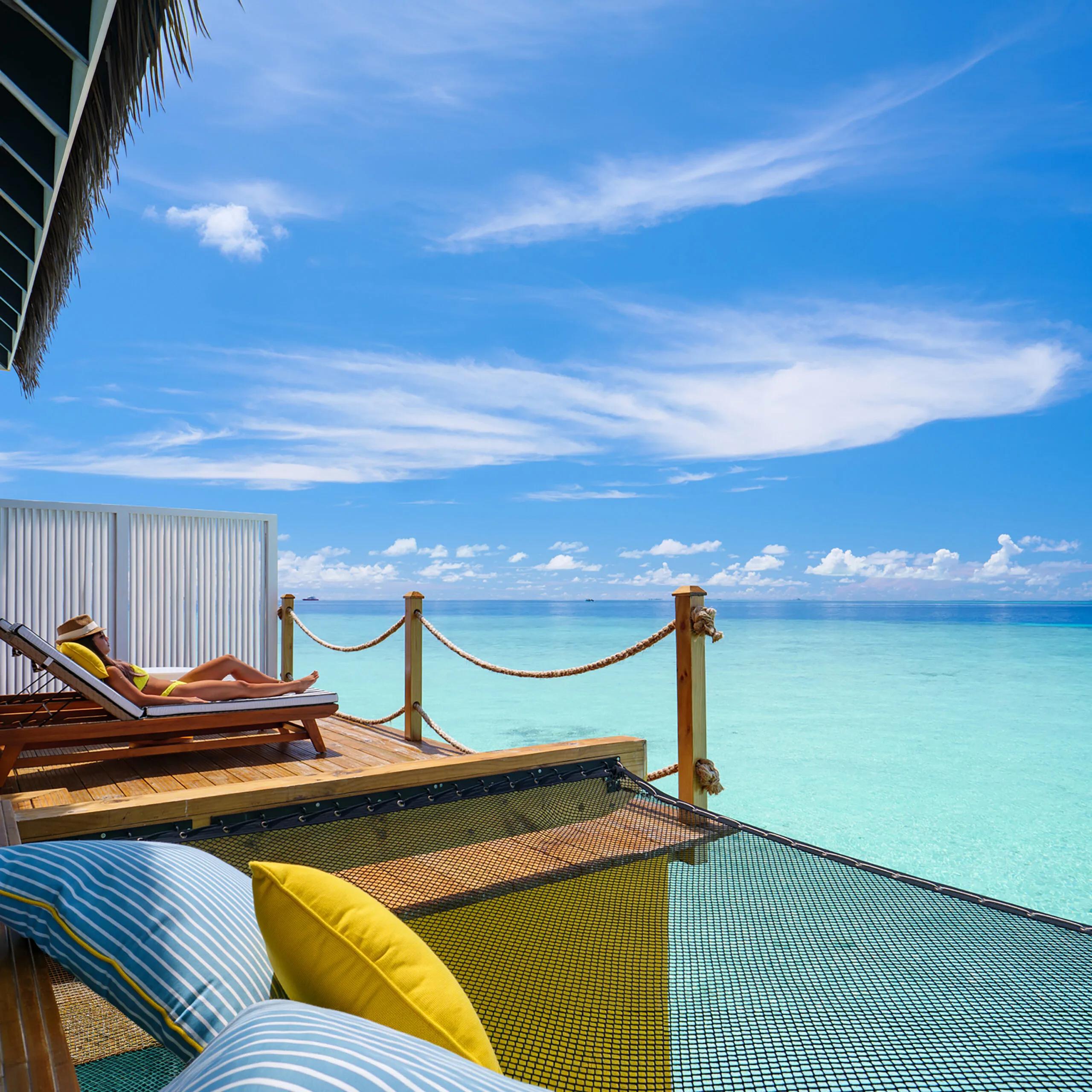 Outdoor deck of an Overwater Villa stepping down to the lagoon at SAii Lagoon Maldives
