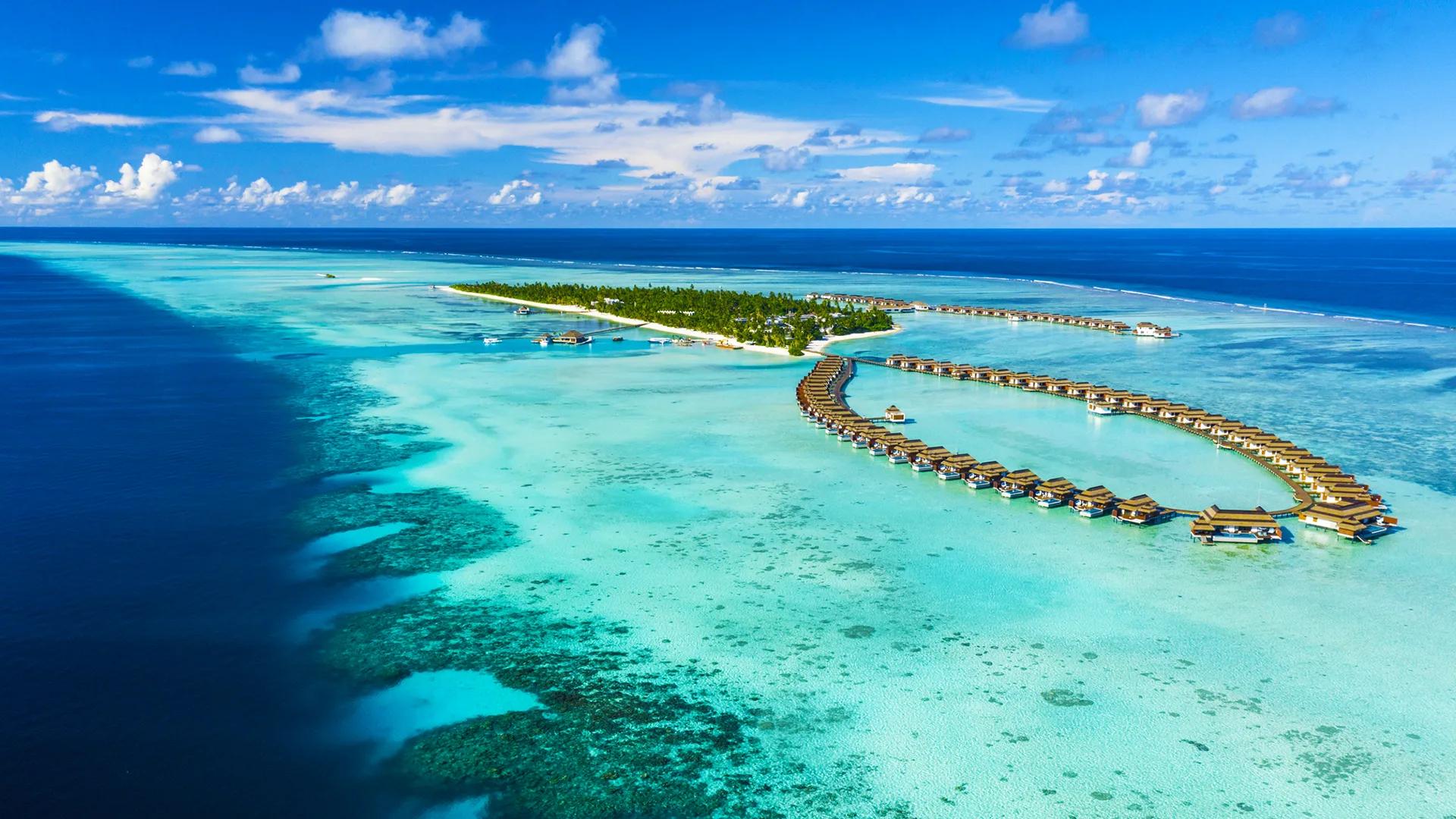 Pullman Maldives Maamutaa's 18-hectare island seen from above, ringed by reef in the southern Maldives