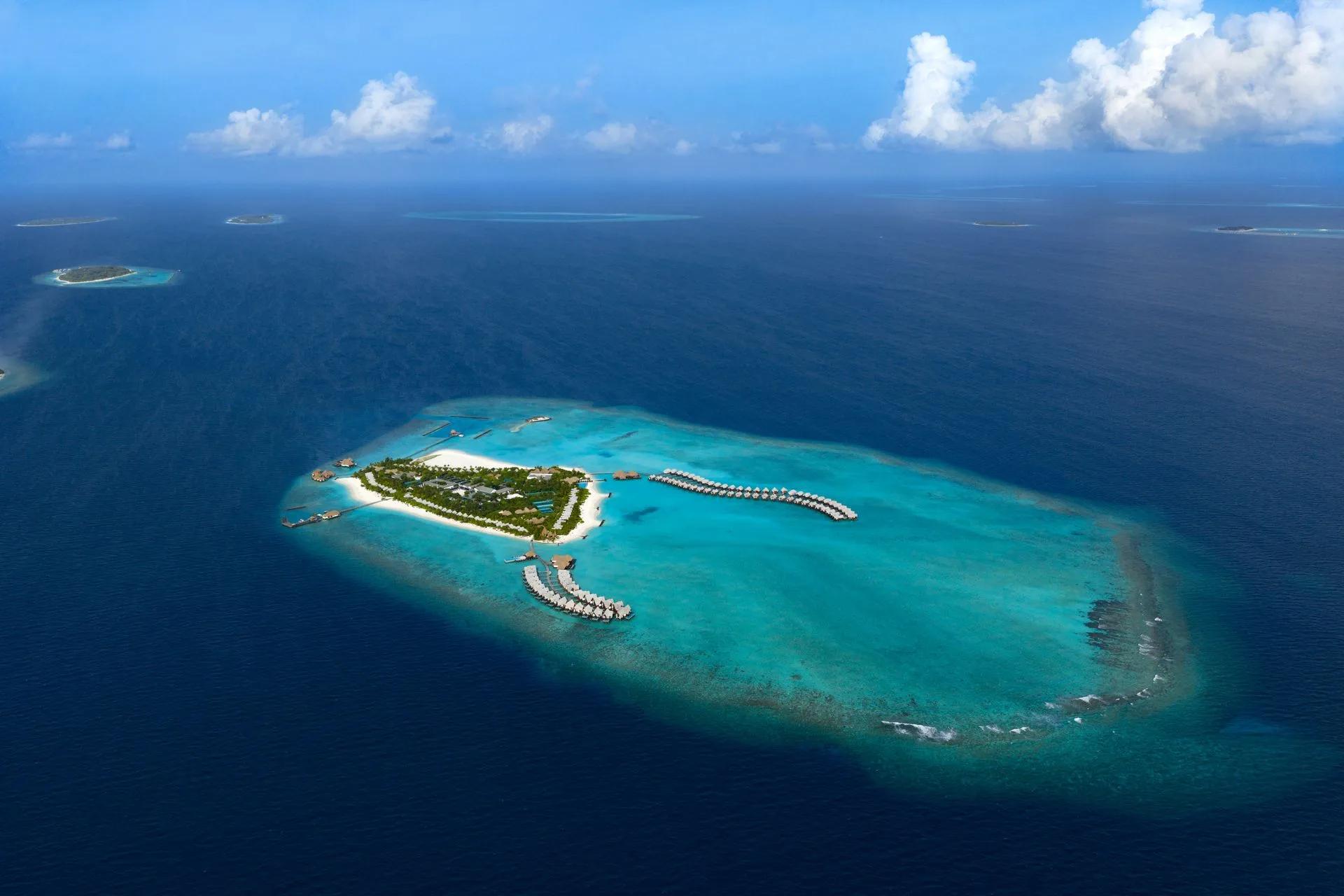 Heritance Aarah's island and surrounding reef seen from above in Raa Atoll