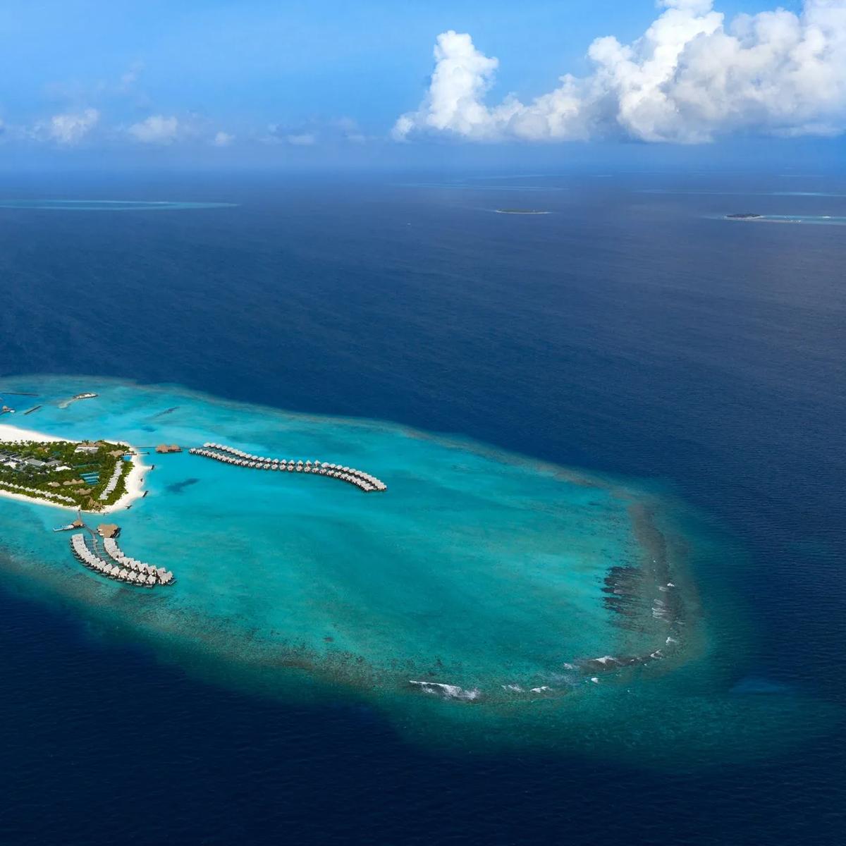 Heritance Aarah's island and surrounding reef seen from above in Raa Atoll