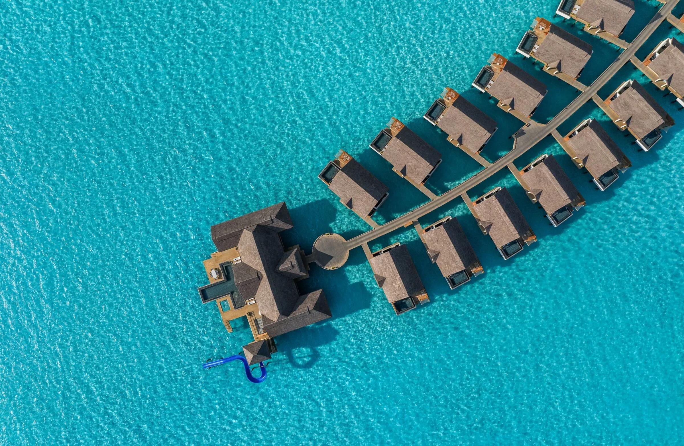 An aerial top-down view of the Ocean Residence's private pool and water slide reaching into the lagoon