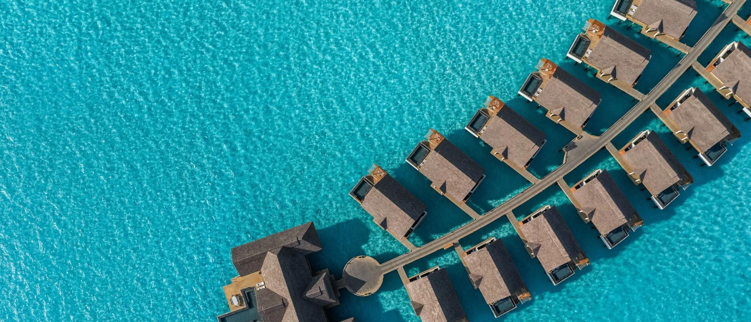 An aerial top-down view of the Ocean Residence's private pool and water slide reaching into the lagoon
