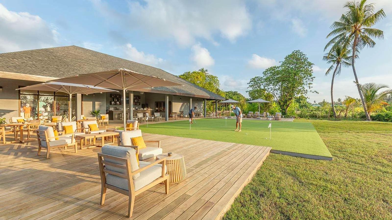 The deck of Hideout Restaurant overlooking Jawakara's golf course, guests putting on the green beyond