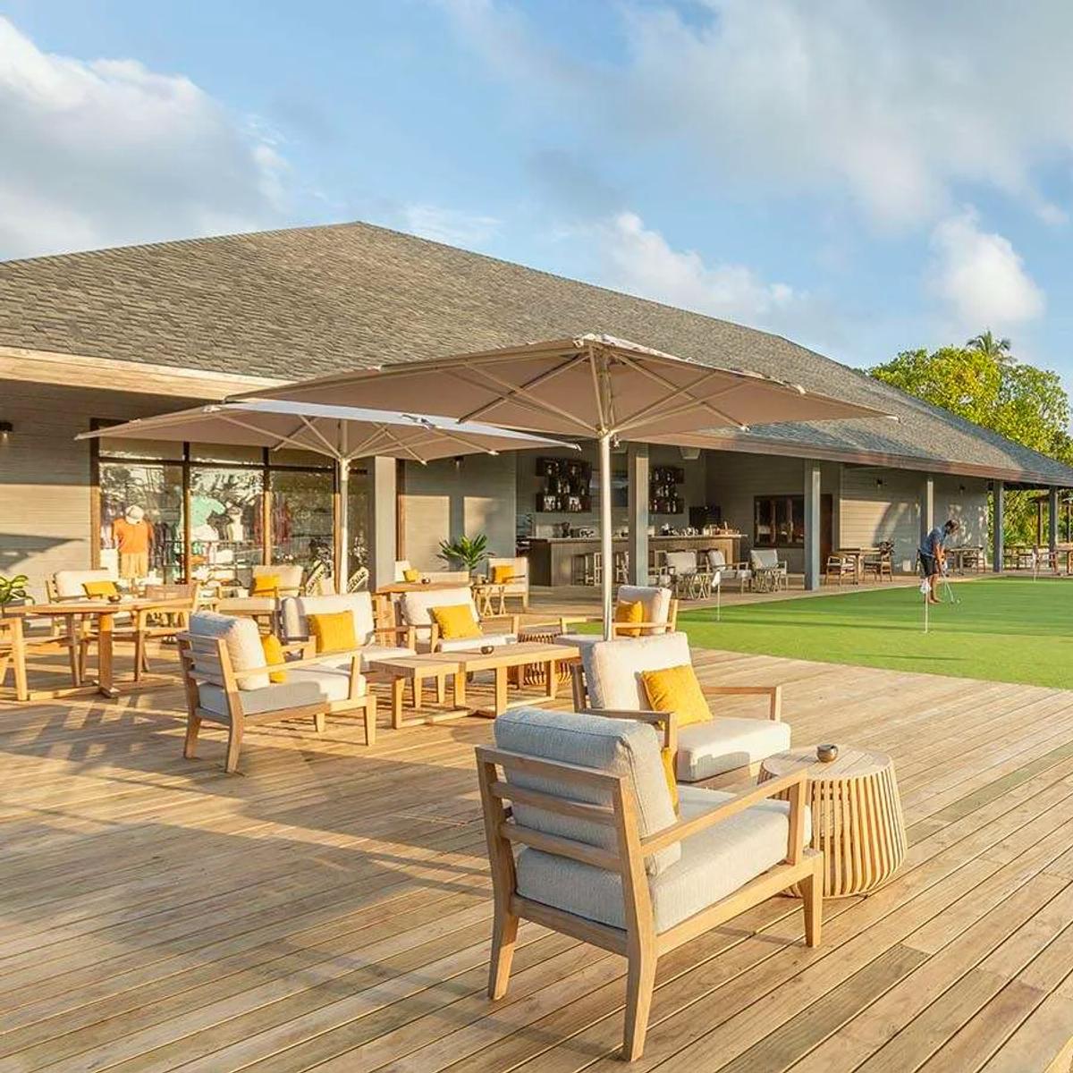 The deck of Hideout Restaurant overlooking Jawakara's golf course, guests putting on the green beyond