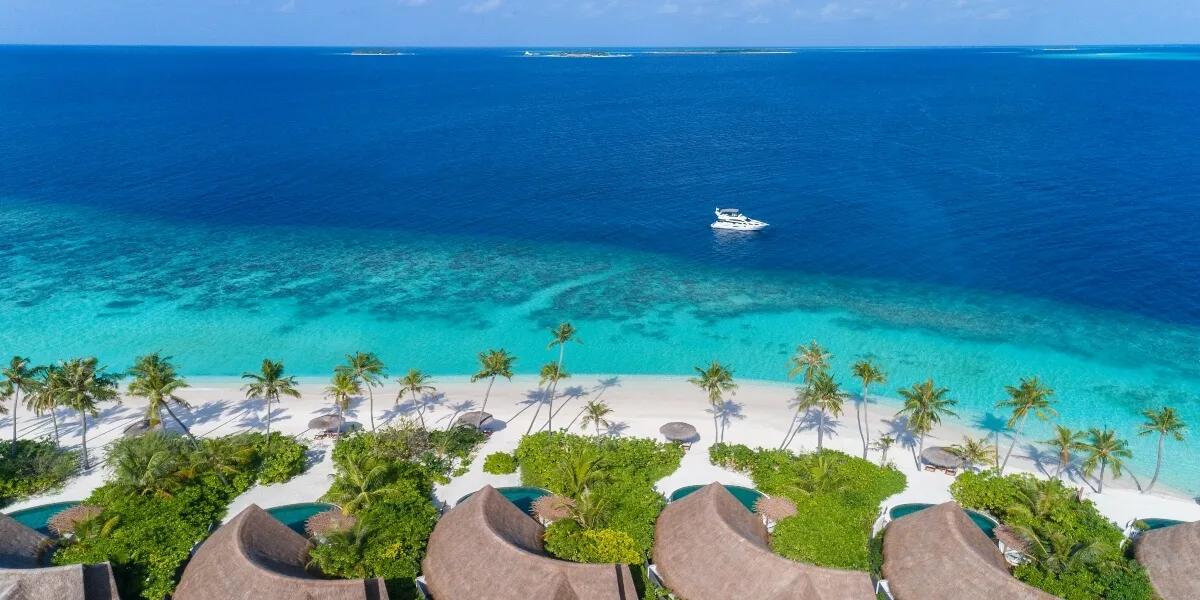 Wide aerial view of Milaidhoo island and its surrounding reef in Baa Atoll.