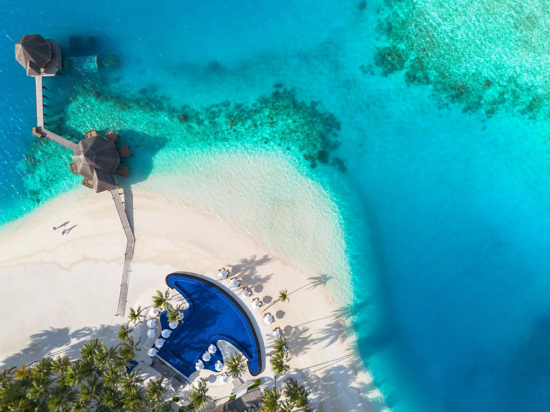 An aerial view of Conrad Maldives Rangali's main pool, Ithaa Undersea Restaurant and Sunset Grill at the tip of Rangali-Finolhu Island