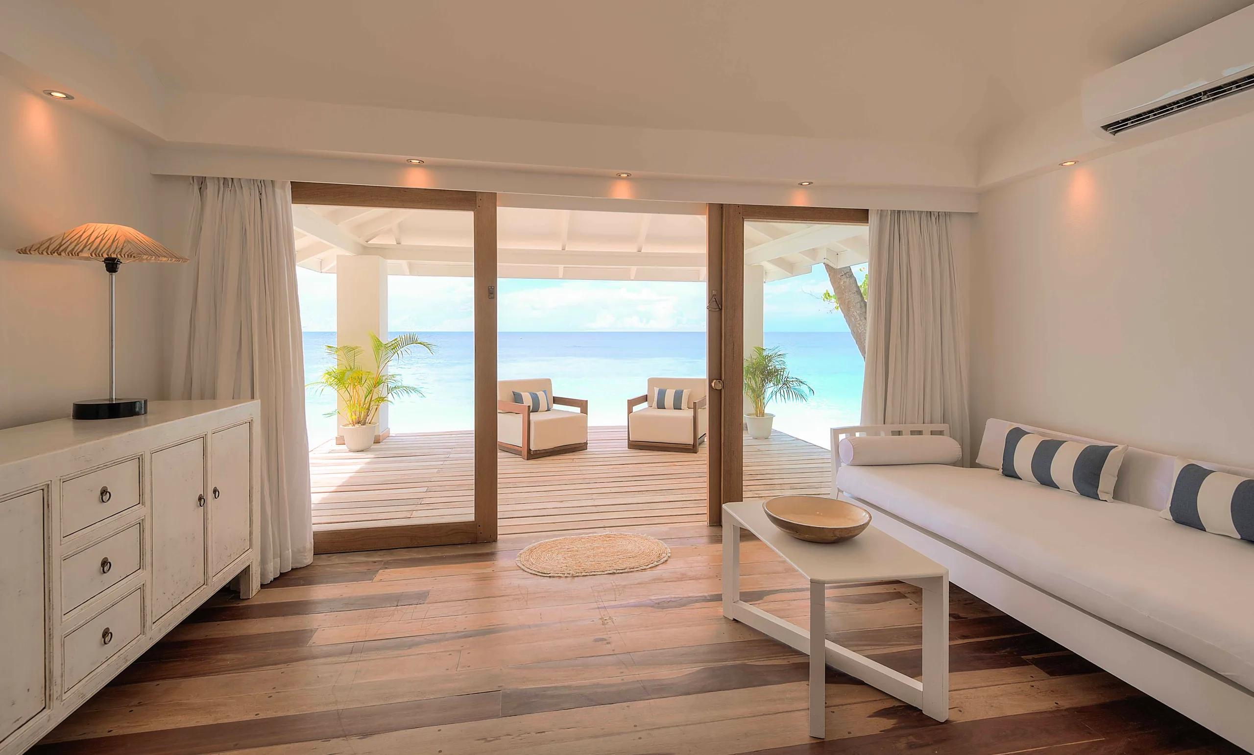 The separate living room of a Beach Front Junior Suite at Diamonds Athuruga, opening onto its veranda