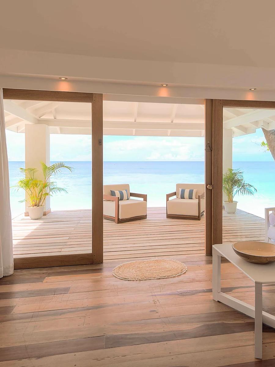 The separate living room of a Beach Front Junior Suite at Diamonds Athuruga, opening onto its veranda