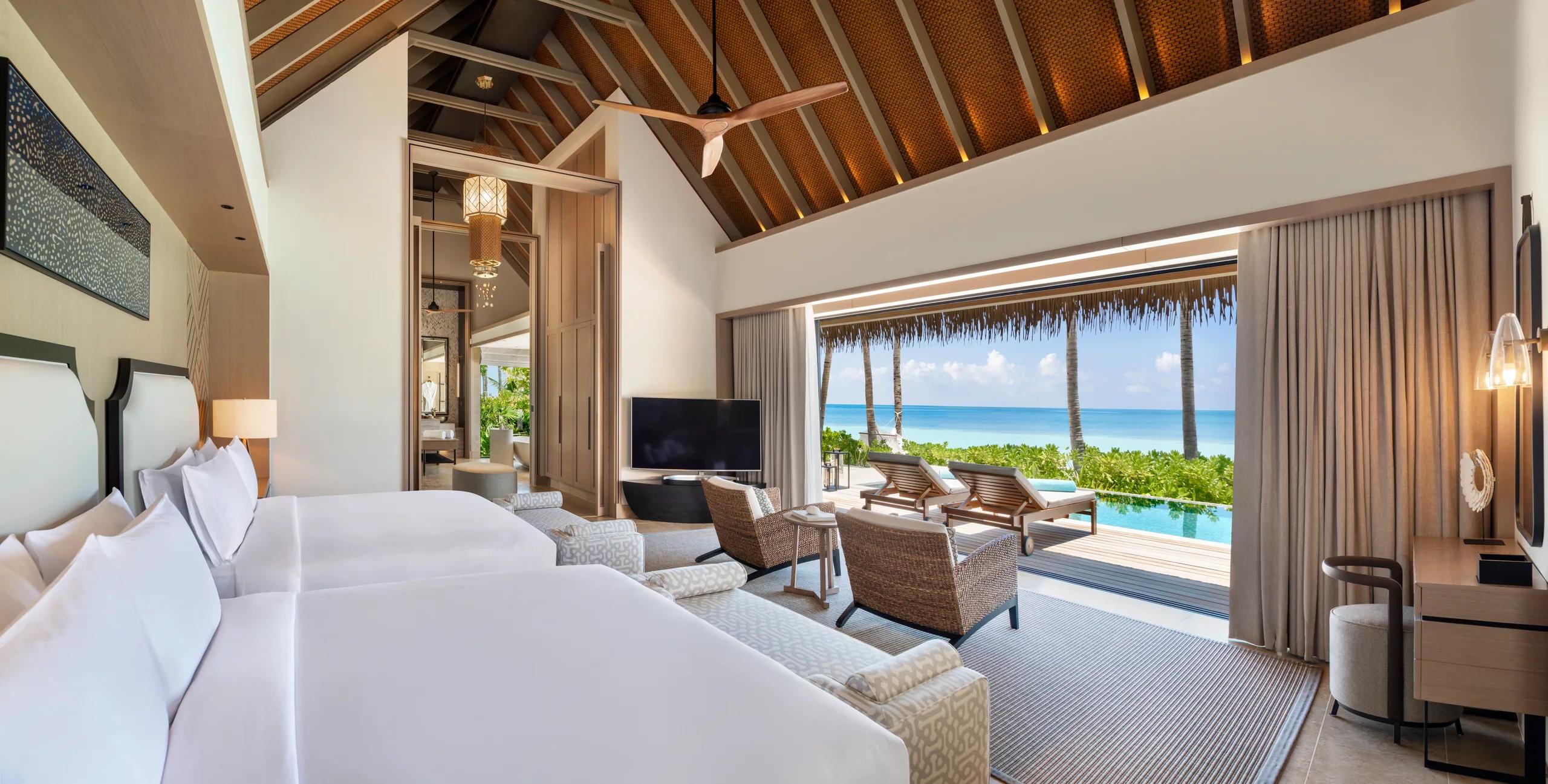 The bedroom of a Beach Villa at Waldorf Astoria Maldives Ithaafushi, opening onto the sand