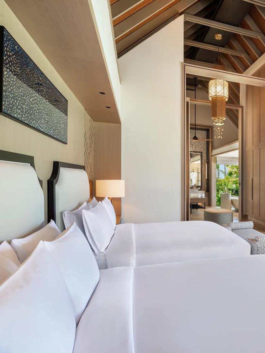 The bedroom of a Beach Villa at Waldorf Astoria Maldives Ithaafushi, opening onto the sand