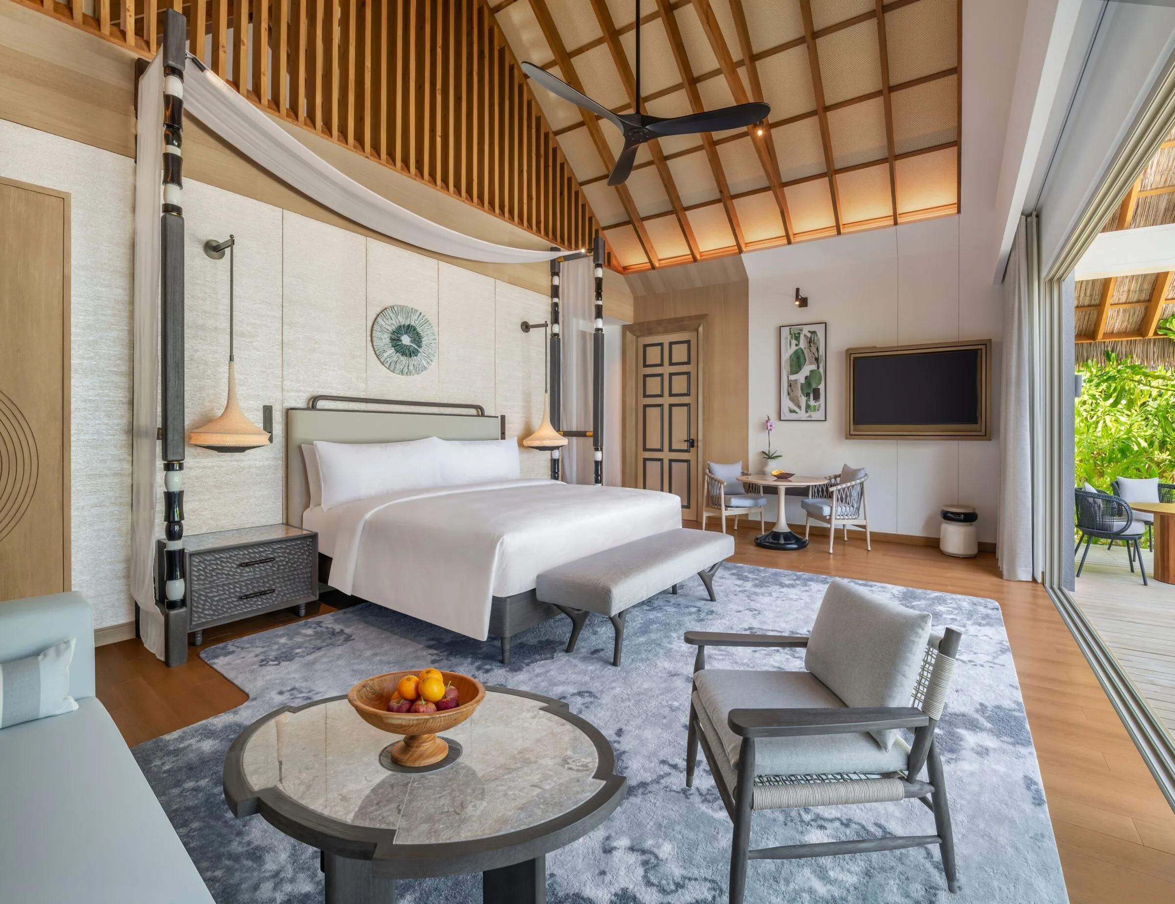A Beach Pool Villa's bedroom, opening onto its deck and pool