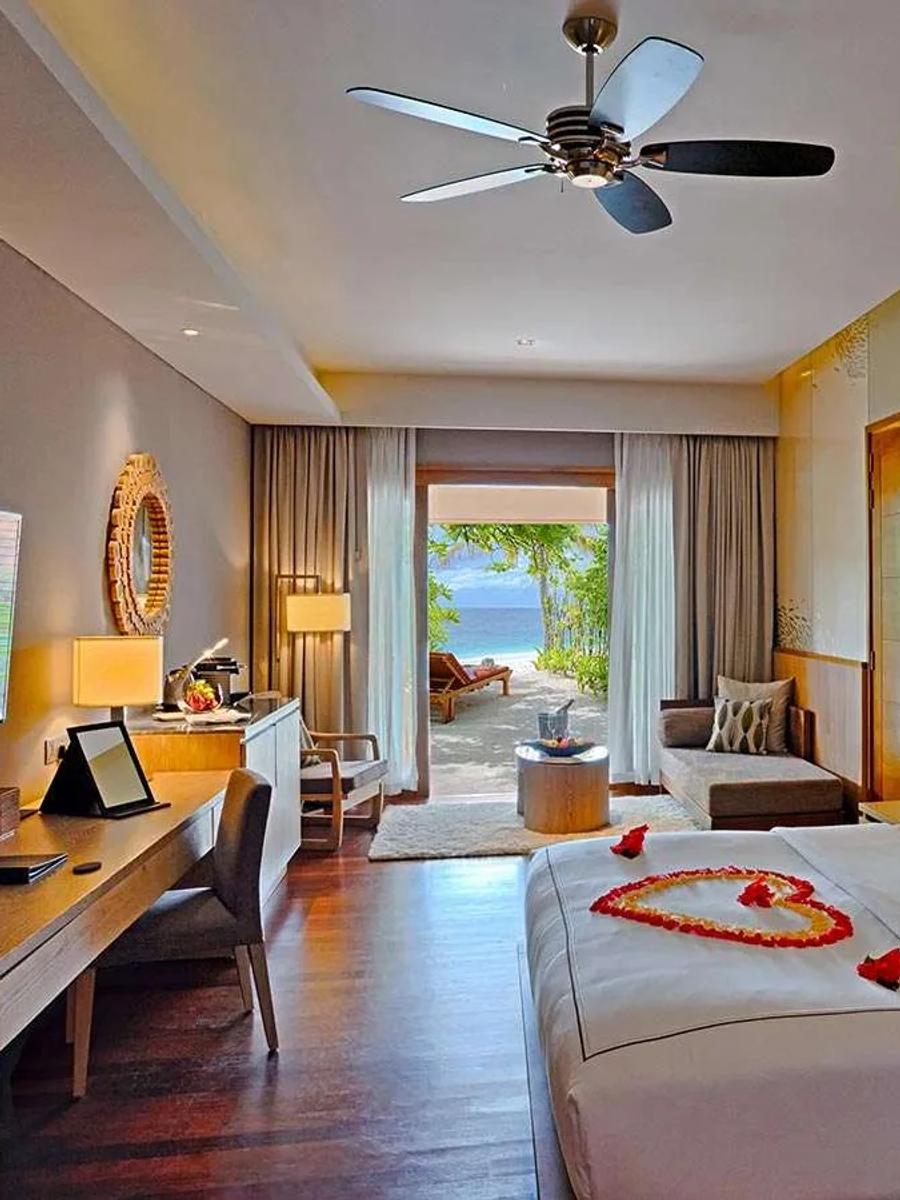 The bedroom of a Beach Suite at Lily Beach Resort & Spa