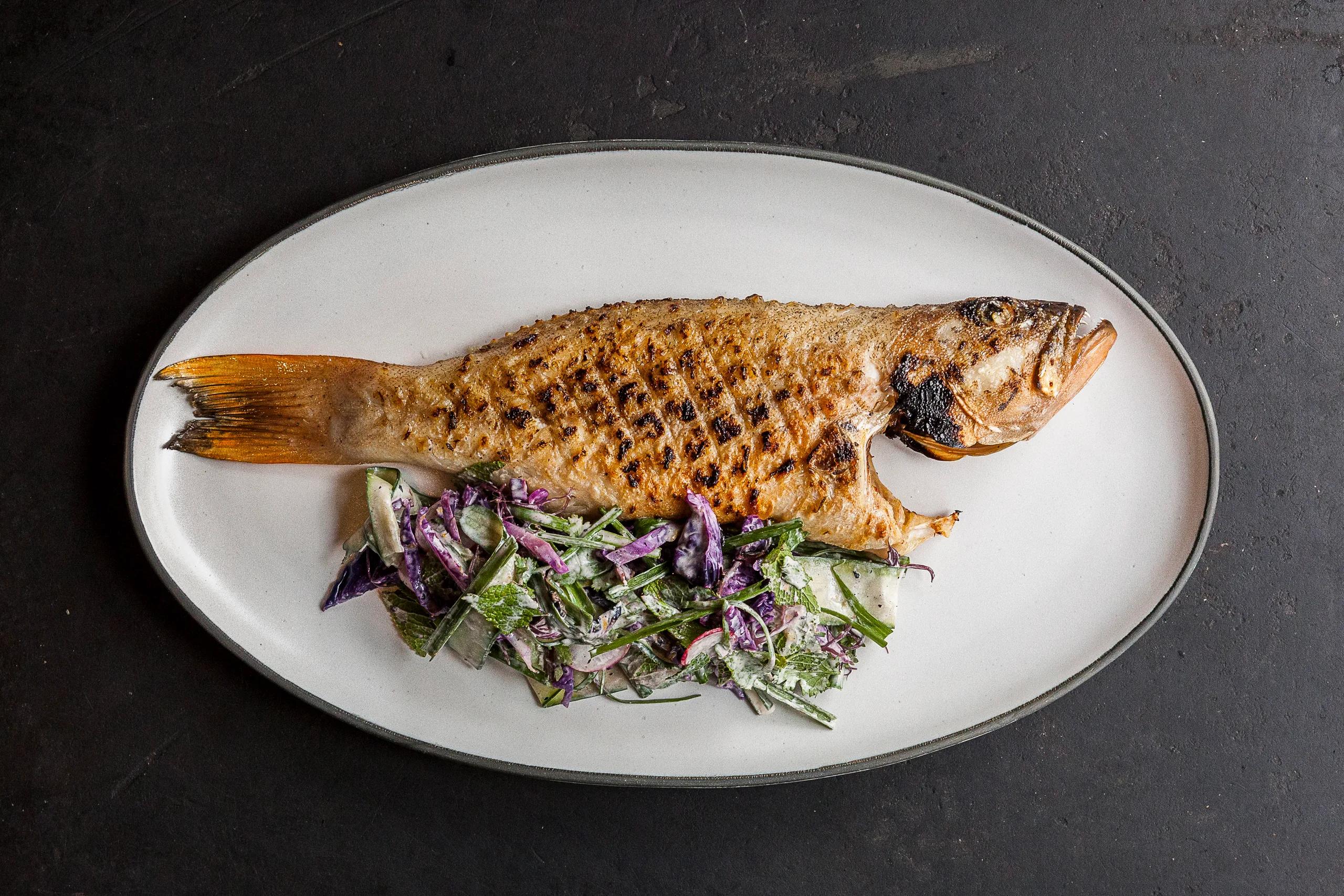 A grilled local grouper dish plated at The Ledge, Waldorf Astoria Maldives Ithaafushi's beachside grill