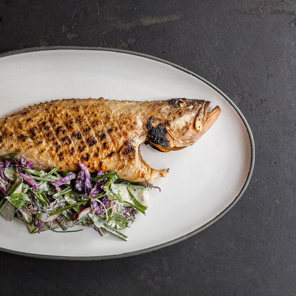 A grilled local grouper dish plated at The Ledge, Waldorf Astoria Maldives Ithaafushi's beachside grill