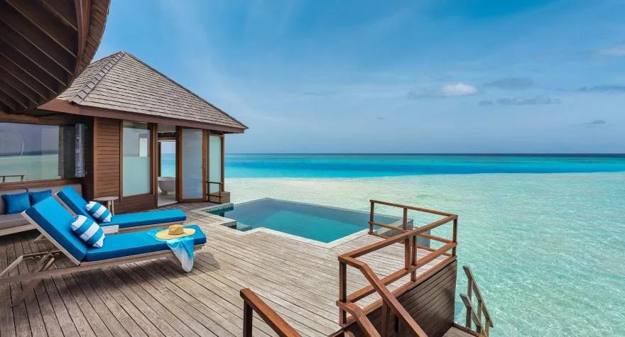 The infinity pool and deck of a Sunset Over Water Pool Suite, perched above the sea