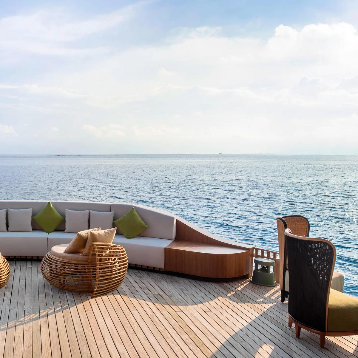 The Pearl's curved overwater lounge deck, seating arranged to face the open ocean