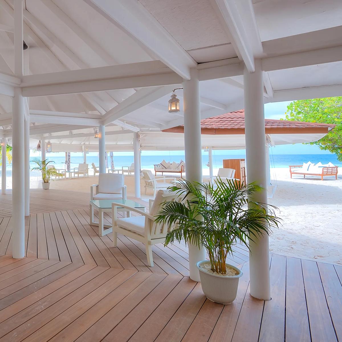Interior of Boli Beach Bar at Diamonds Athuruga, open to the sand and sea beyond