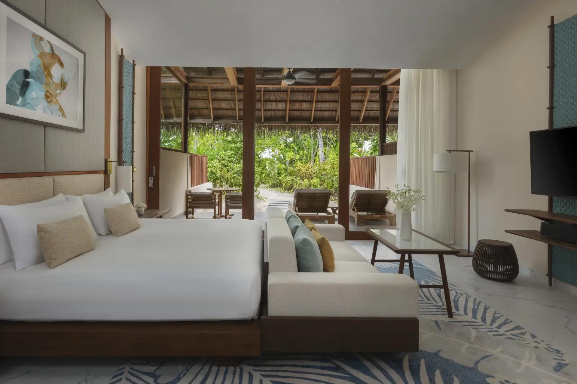 A Beach Villa's garden terrace at Conrad Maldives Rangali, sun loungers and umbrella facing the lagoon