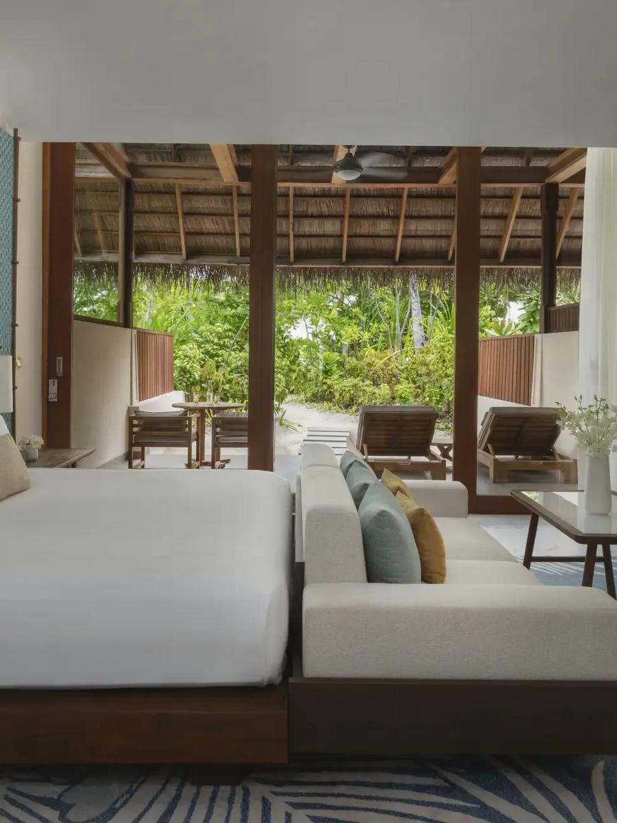 A Beach Villa's garden terrace at Conrad Maldives Rangali, sun loungers and umbrella facing the lagoon