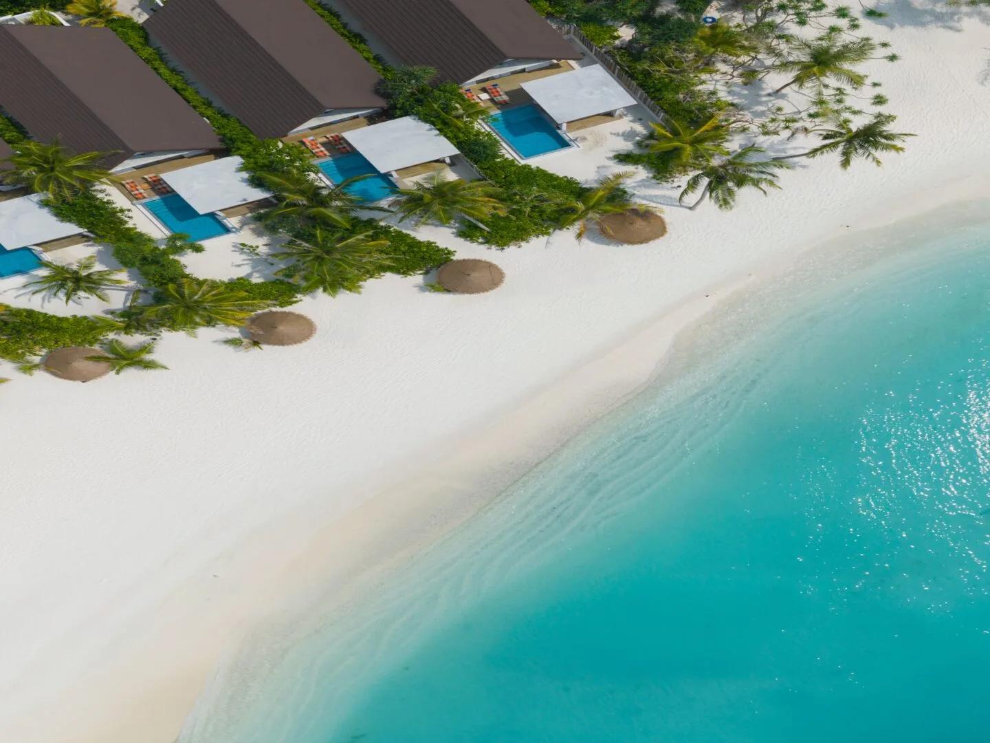 An early aerial view of Meyyafushi's beach and villa rows taken ahead of the resort's June 2026 opening